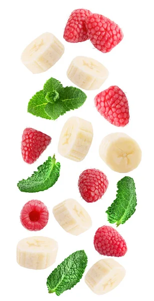 Flying fresh raspberry, banana and mint leaves isolated on white background with clipping path as package design element and advertising. Full depth of field.