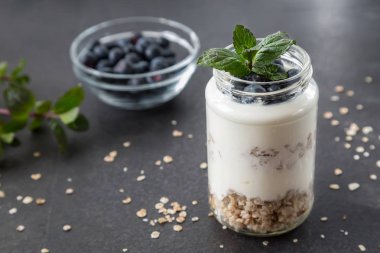 yoğurt ile tahıl ve meyve üzerinde strewed kadehi nane yaprakları