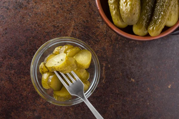 Pickled gherkins with mustard and garlic on a stone rusty background. — Stock Photo, Image