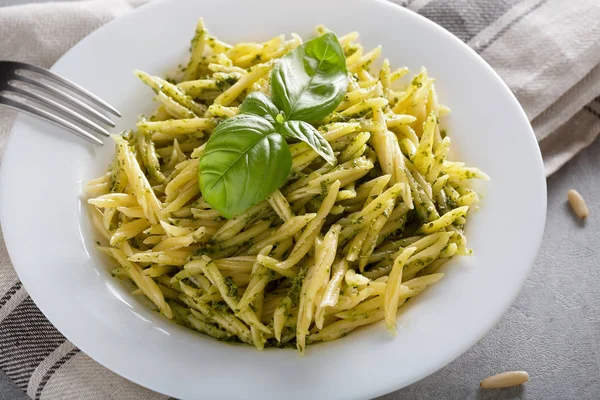 Traditional trofie pasta with pesto sauce on white plate — Stock Photo, Image