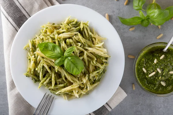 Beyaz plaka üzerinde pesto sos ile geleneksel trofie makarna