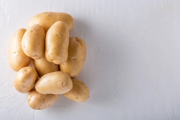 Raw organic potatoes on a white background