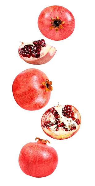 Falling in air fresh ripe whole and cut pomegranate — Stock Photo, Image