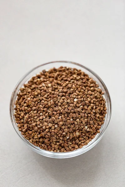 Bowl of buckwheat isolated on white background. Top view. — Stock Photo, Image