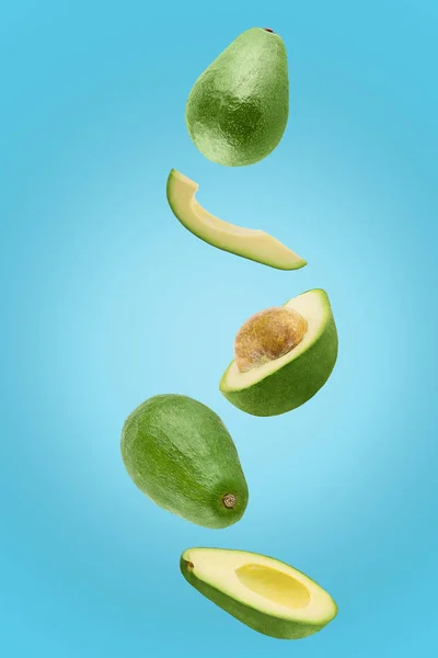 Avocado sliced isolated in blue background viewed from above