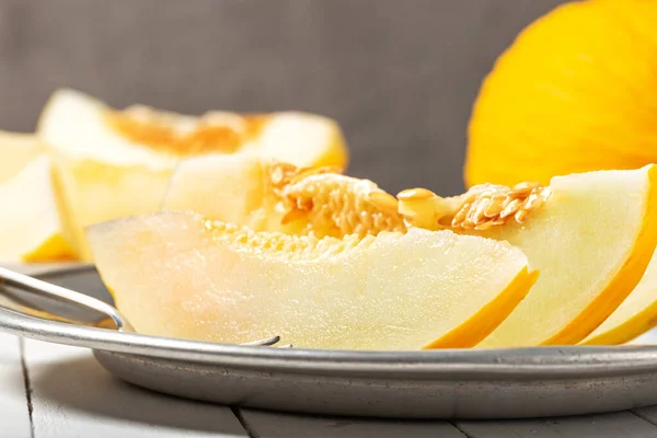 Sweet yellow fresh melon on wooden table