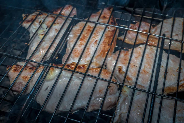 Meat cooking on the grill with open fire and coals — Stock Photo, Image