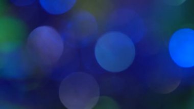 Renkli daireler yanıp sönen bulanık arka plan