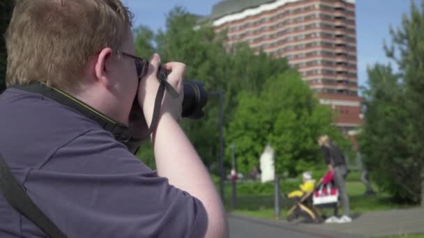 Jongeman maakt foto 's in het park — Stockvideo