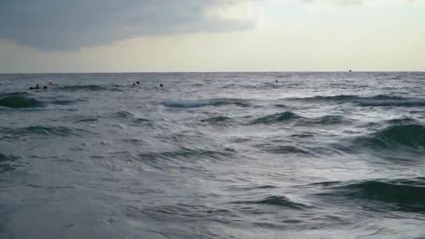 Menschen am Abend schwimmen im Meer. Zeitlupe — Stockvideo