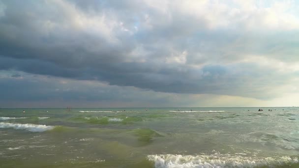 La gente por la noche nada en el mar. Movimiento lento — Vídeos de Stock