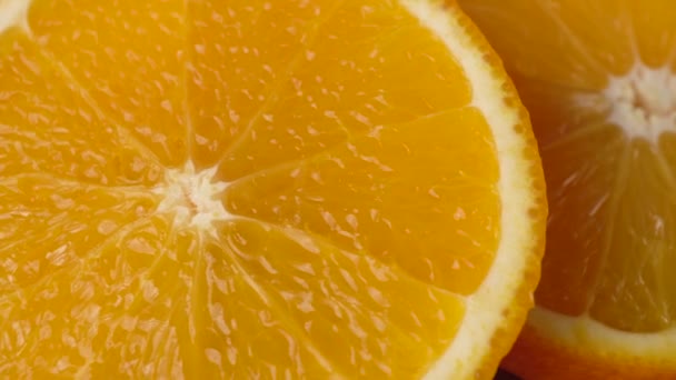 Sliced orange closeup on a black background — Stock Video