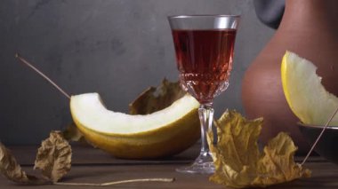 Dilimlenmiş karpuz, kil testi şarap ve sonbahar yapraklarıyla hayat