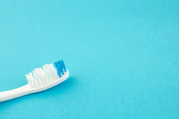 toothpaste and brush on a blue background with place for text. Health, cleanliness and beauty