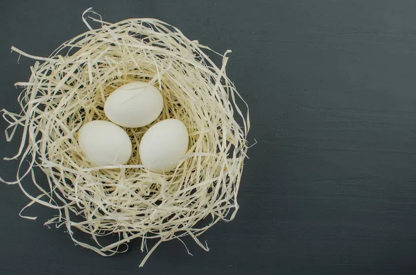 Top view of fresh egg white on straw. chicken egg in the nest — Stock Photo, Image