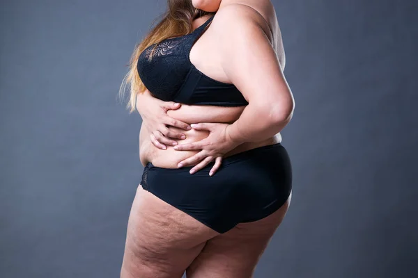 Plus size model in black lingerie, overweight female body, fat woman with  flabby stomach isolated on white background Stock Photo by ©starast  138180764