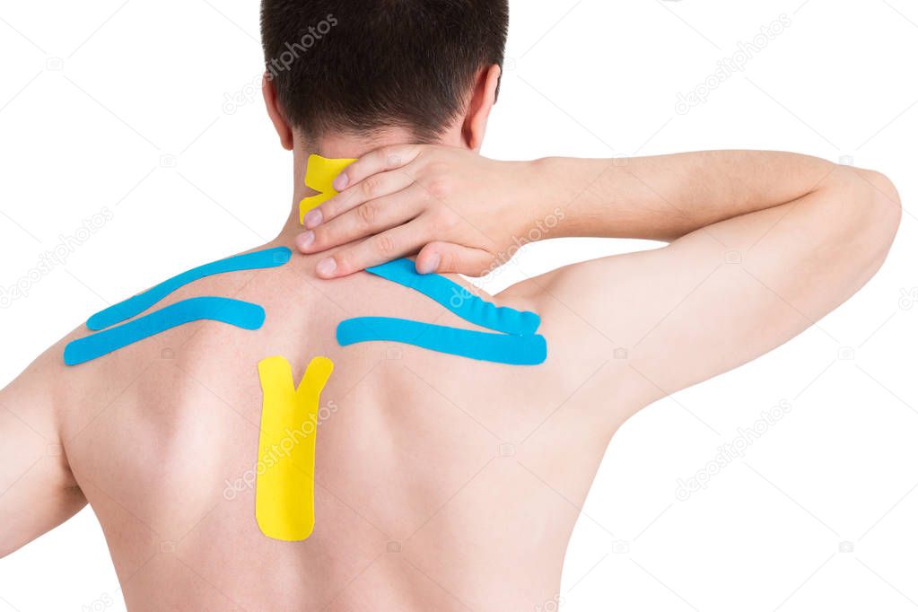 Kinesiology taping on human back, isolated on white background