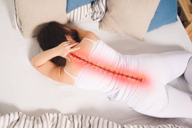 Pain in the spine, woman with backache at home, back injury, photo with highlighted skeleton clipart