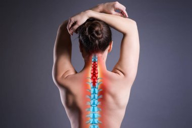 Pain in the spine, woman with backache on gray background, back injury, photo with highlighted skeleton clipart