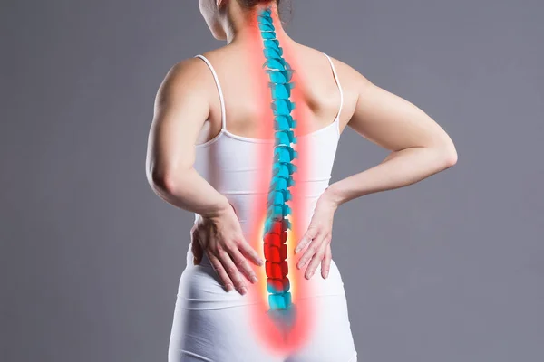 Pain in the spine, woman with backache on gray background, back injury, photo with highlighted skeleton — Stock Image Pain Spine Woman Backache Gray Background Back Injury Photo Highlighted Stock Photo