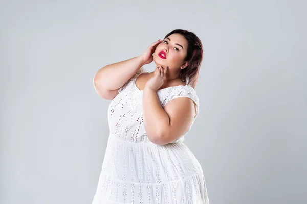 Young beautiful plus size model in black dres, xxl woman on gray studio  background Stock Photo by ©starast 132129610