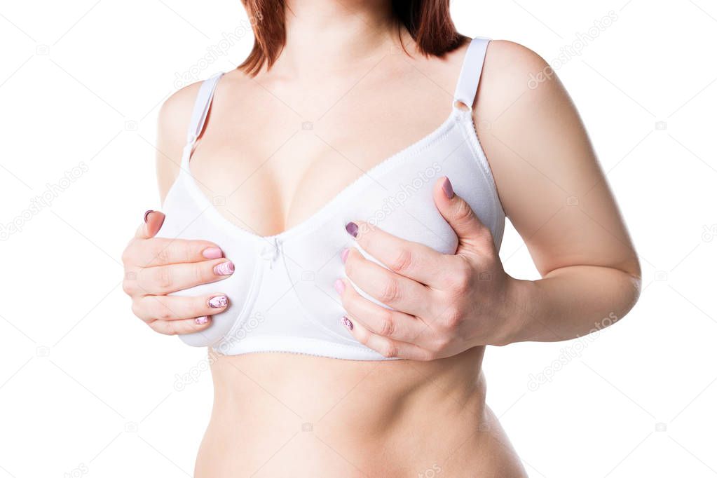 Breast test, woman examining her breasts for cancer, big natural boobs isolated on white background