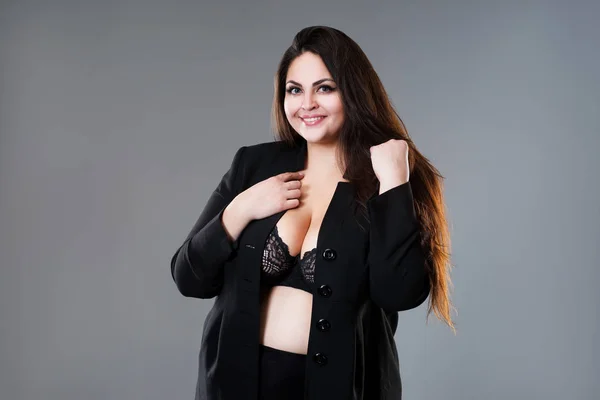 Glücklich plus size fashion model in sexy Klamotten, dicke Frau auf grauem Studiohintergrund, body positive concept — Stockfoto