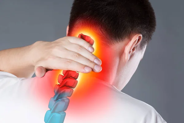 Pain in the spine, a man with backache, injury in the human neck, chiropractic treatments concept — Stock Image Pain in the spine, a man with backache, injury in the human neck, chiropractic treatments concept Royalty Free Stock Images