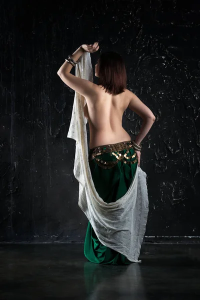 Sexy women performs belly dance in ethnic dress on black background, abstract art photography — Stock Photo, Image