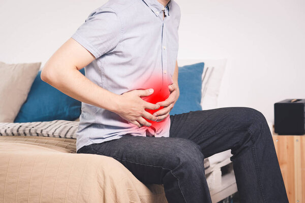 Stomach ache, man with abdominal pain suffering at home
