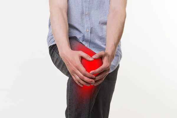 Man with pain in knee, studio shot on white background — Stock Photo, Image