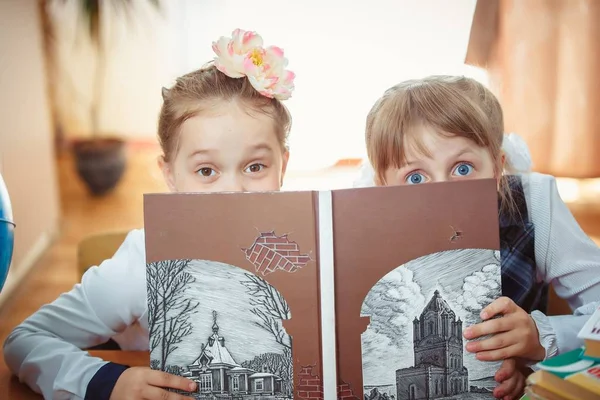 Deux écolières avec un livre — Photo