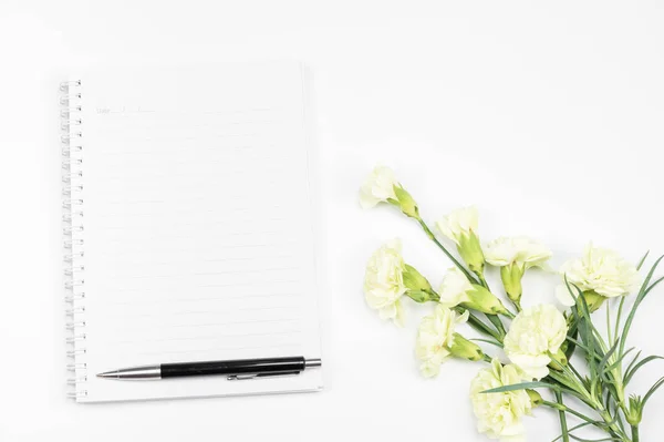 Cuaderno en blanco con pluma y flor de clavel blanco sobre blanco — Foto de Stock