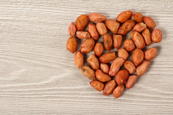 Fıstık gri ahşap kurullarında bir kalp şeklinde. Kopya alanı ile üstten görünüm