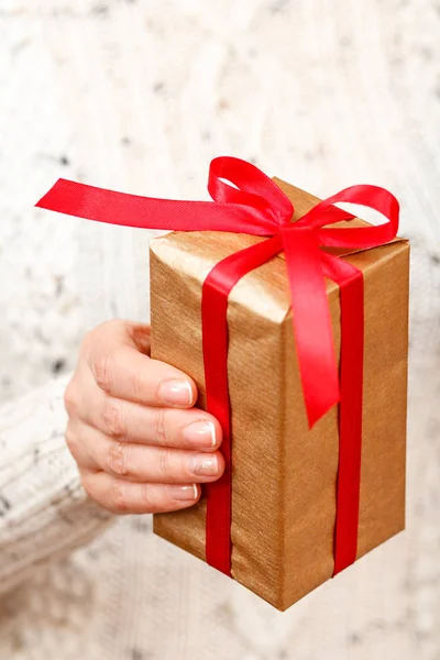 Woman Holding Gift Box Tied Red Ribbon Her Hand Shallow — Stock Photo, Image