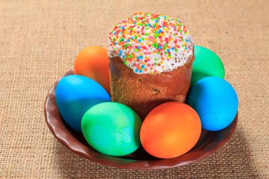 Paskalya kek ve bir plaka üzerinde boyalı yumurta ile arka planda tutuyordu. Geleneksel Ortodoks Hıristiyan Paskalya yemek.