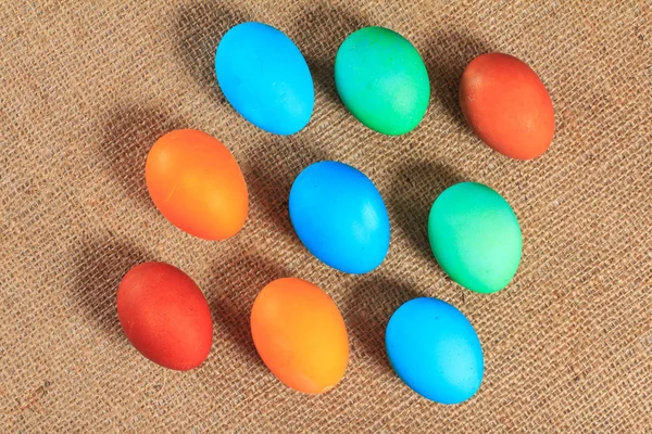 Painted eggs on sackcloth as a background.
