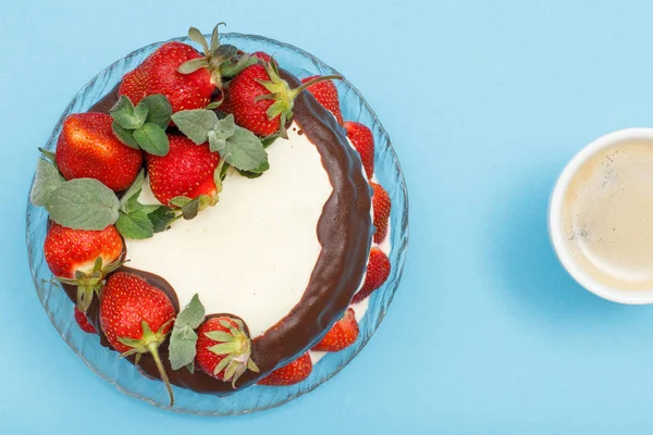Домашній шоколадний торт, прикрашений свіжою полуницею на скляній тарілці та чашкою кави . — стокове фото