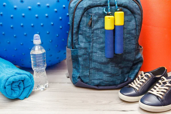 Different tools for fitness on floor in room.