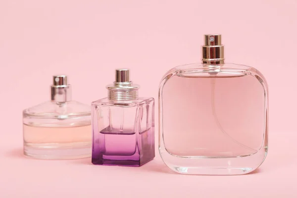 Women perfumes on the pink color background. — Stock Photo, Image