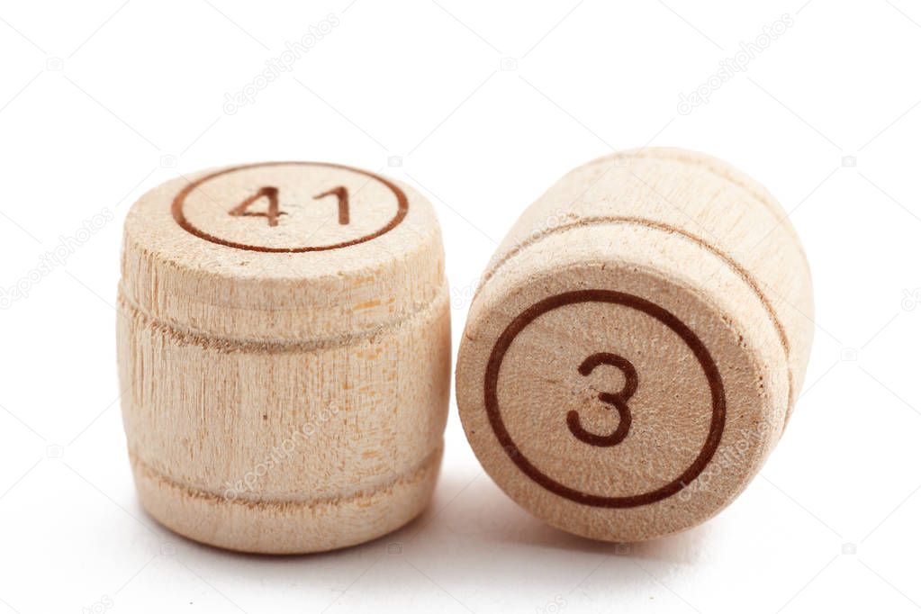 Wooden barrels for a lotto game on a white isolated background.