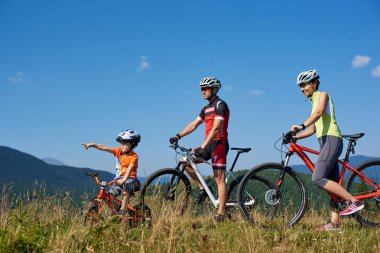 Verkhovyna, Ukrayna - 19 Ağustos 2017: turist aile modern bisiklet üstünde tepe-in dağ çimenli tepe Karpat Dağları'nın güzellik zevk ile 