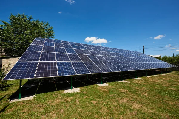 Front view of big solar panels installed on outdoors opened space.