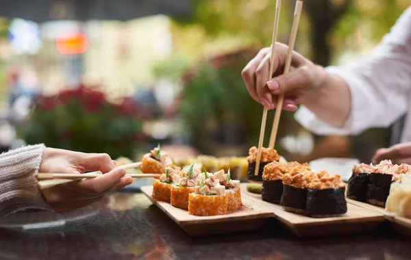 Cerca Amigas Disfrutando Sabroso Sushi Conjunto Algunos Rollos Que Sirven — Foto de Stock