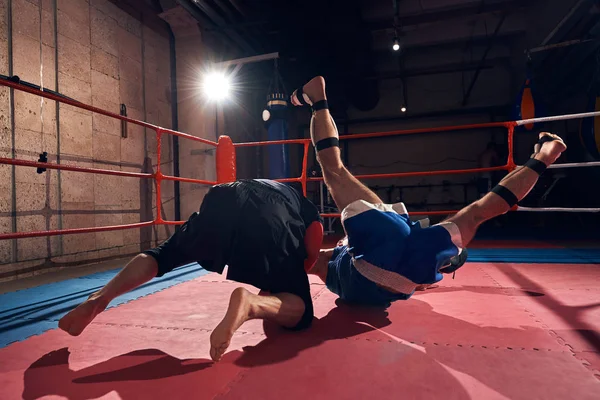 aggressive man boxer training mma with his trainer