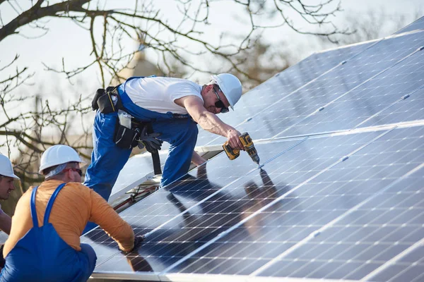 Male engineers installing stand-alone solar photovoltaic panel system