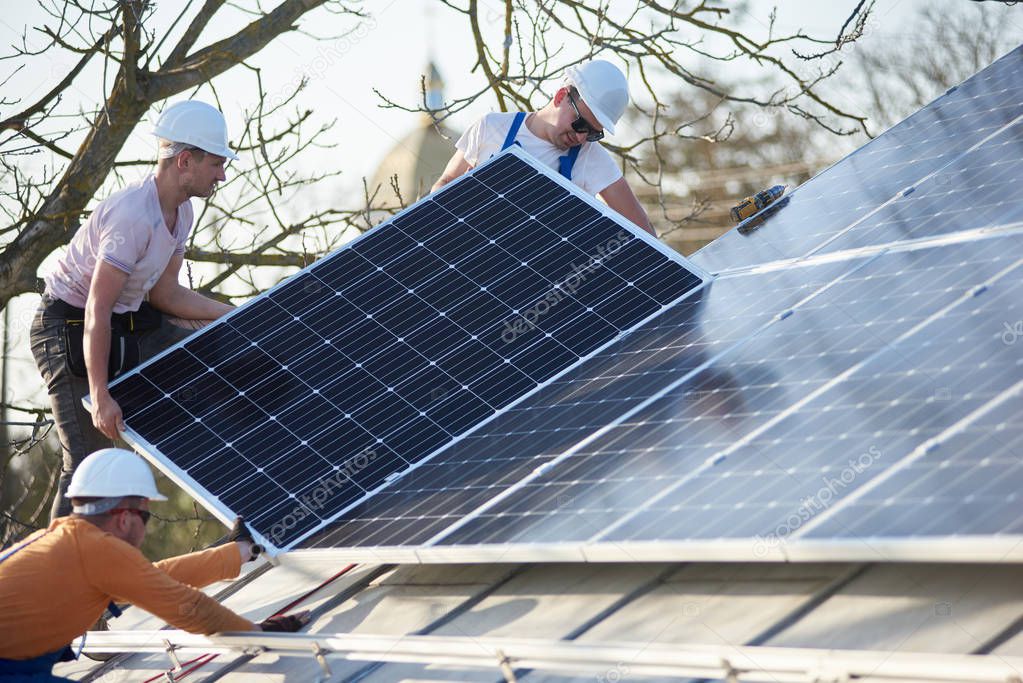 Male engineers installing stand-alone solar photovoltaic panel system