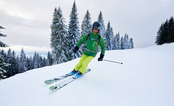 Skier man backcountry skiing on ski slope during vacation time