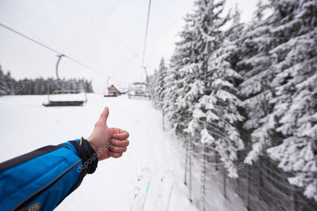 Cropped photo of skier hand, amazing mountain hill, blurred view