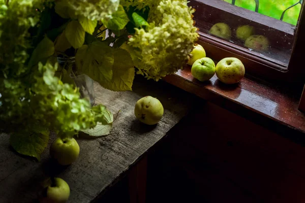 木制桌子上的鲜花和苹果 — 图库照片